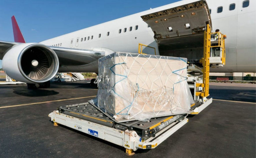 Wooden case being loaded into airplane